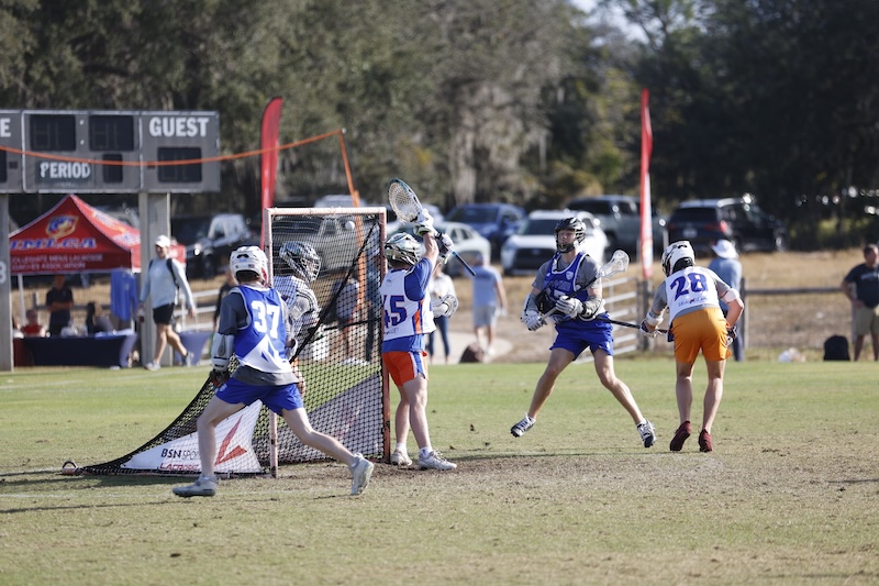 Lacrosse players attack the net at the Players Summit